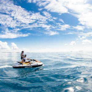 Enjoy a thrilling jet ski ride in the serene waters of Kaafu Atoll, Maldives.
